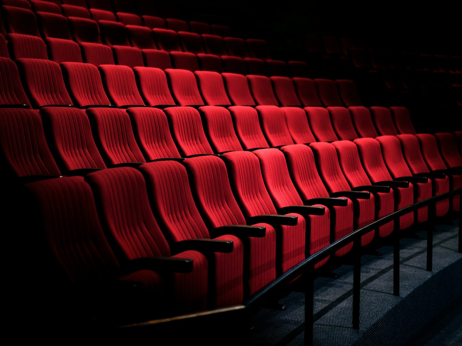 Rows of red seats in an empty theater